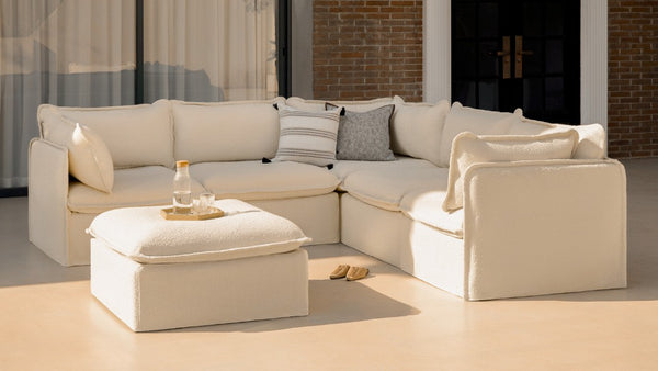 Lifestyle image of a modular 5-seater corner sectional in Creme fabric, highlighting spacious modular corner sectional configurations.