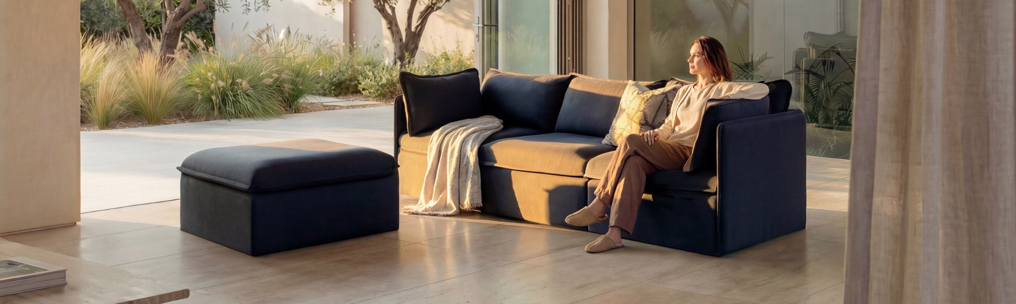 Lifestyle banner image of a modular 3-seater sectional + ottoman in Charcoal fabric styled in a real home setting, highlighting a 30-day risk-free trial.