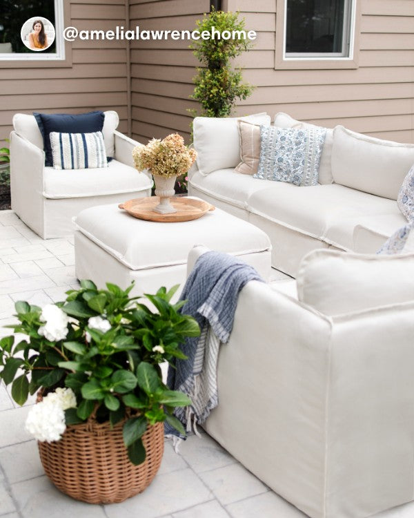 Lifestyle image of a Modular Outdoor Washable 3-Seater Sofa and Armchair Set in Nano Slubweave Mist, shown in a real customer outdoor setting.