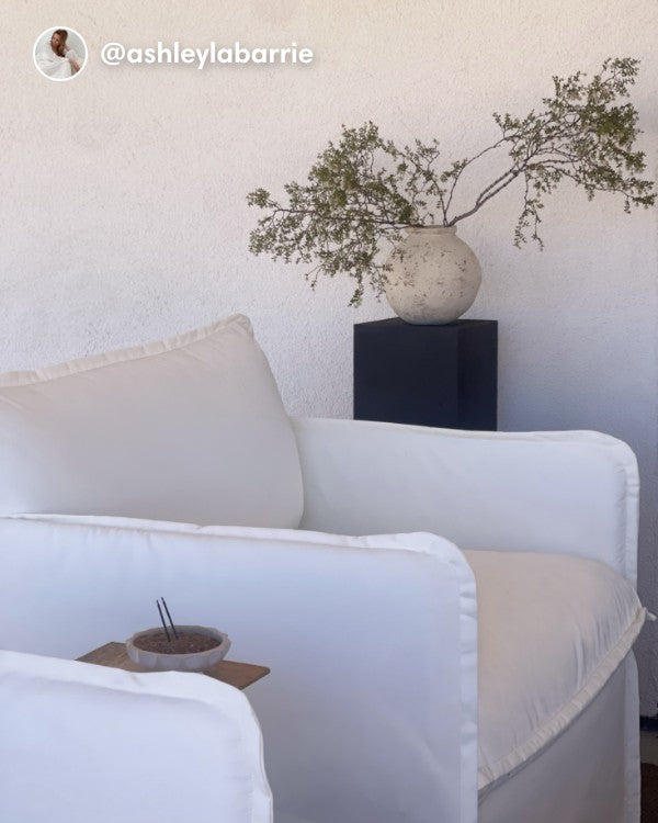 Lifestyle image of a Modular Outdoor Armchair Set in Classic Canvas Cloud, shown in a real customer outdoor setting.