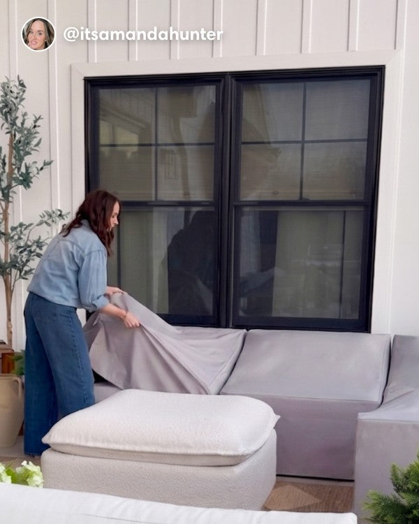 Lifestyle image of a customer removing the All-Season Outdoor Protective Cover Set for a Washable 5-Seater Corner Sectional with Ottoman, shown in a real customer outdoor setting.