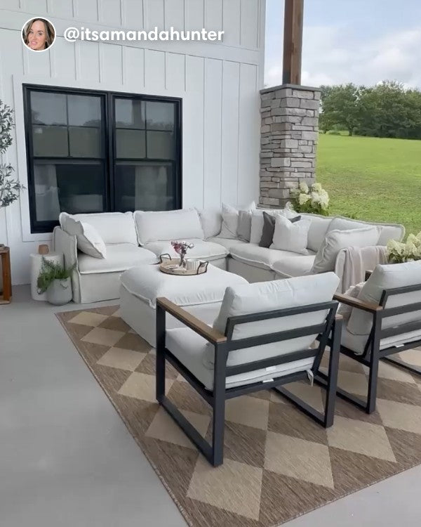 Lifestyle image of a Modular Outdoor Washable 5-Seater Corner Sectional with Ottoman in Alfresco Boucle Creme, shown in a real customer outdoor setting.