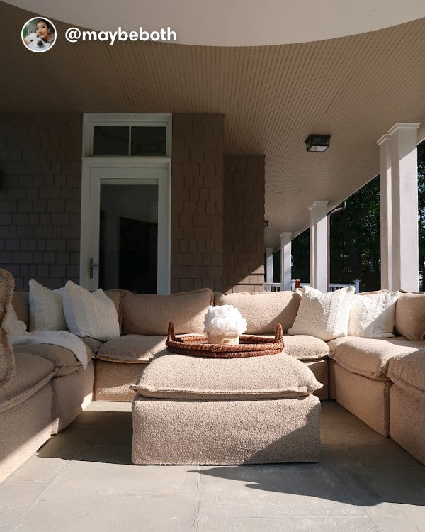 Lifestyle image of a Modular Outdoor Washable 8-Seater U-Sectional with Ottoman in Alfresco Boucle Cashew, shown in a covered outdoor space at a real customer home.